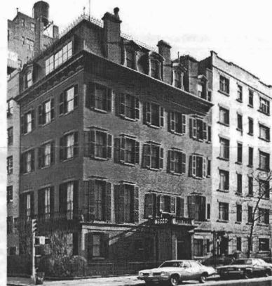 Black-and-white archival photograph of the corner mansion and its adjoining buildings.