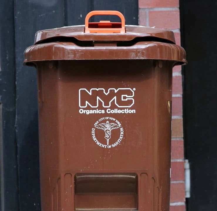A brown NYC organics collection bin.