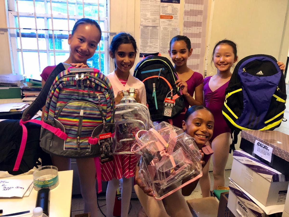 Children with backpacks provided through the neighborhood’s educational support efforts.
