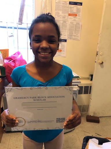 A student holds a GPBA certificate.