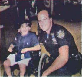 An officer gives Jonah a police hat.