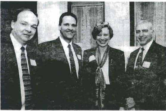 Four reception attendees, identified by the printed caption as Richard Heegan, Owen Hughes, Claire Haaga and Steven Anger.