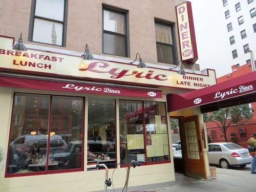 The Lyric Diner’s red awning and storefront at a neighborhood corner.