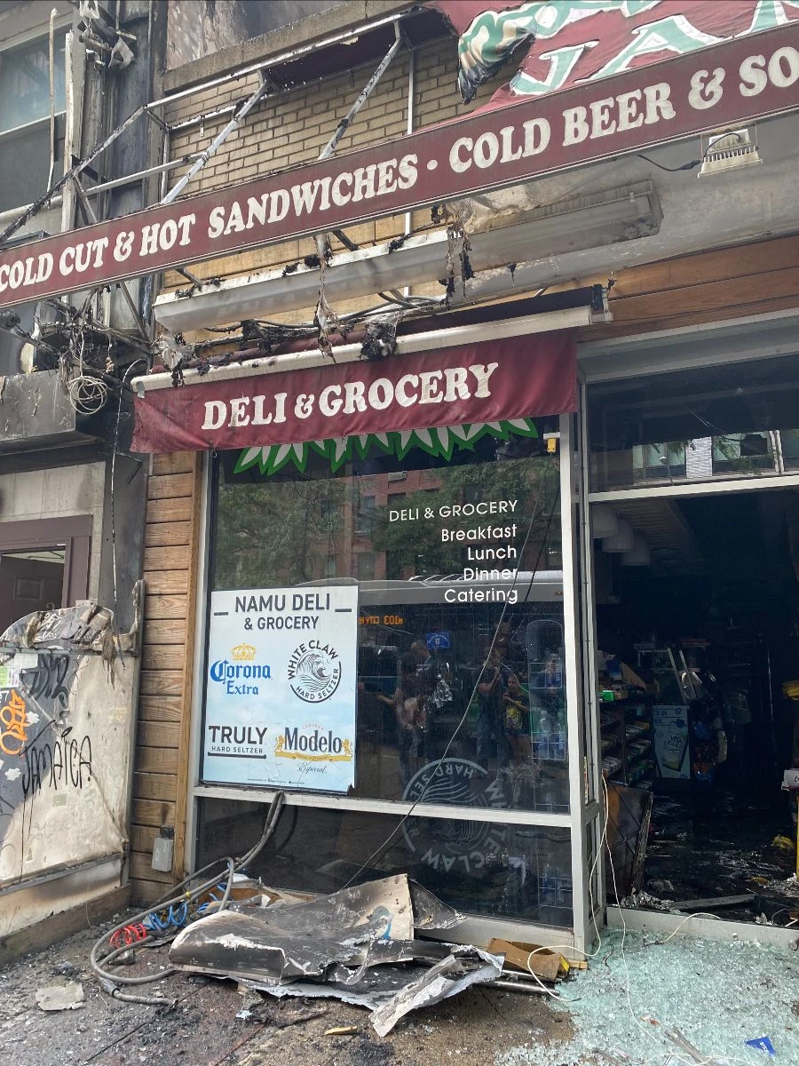 Fire damage and debris at the deli entrance.