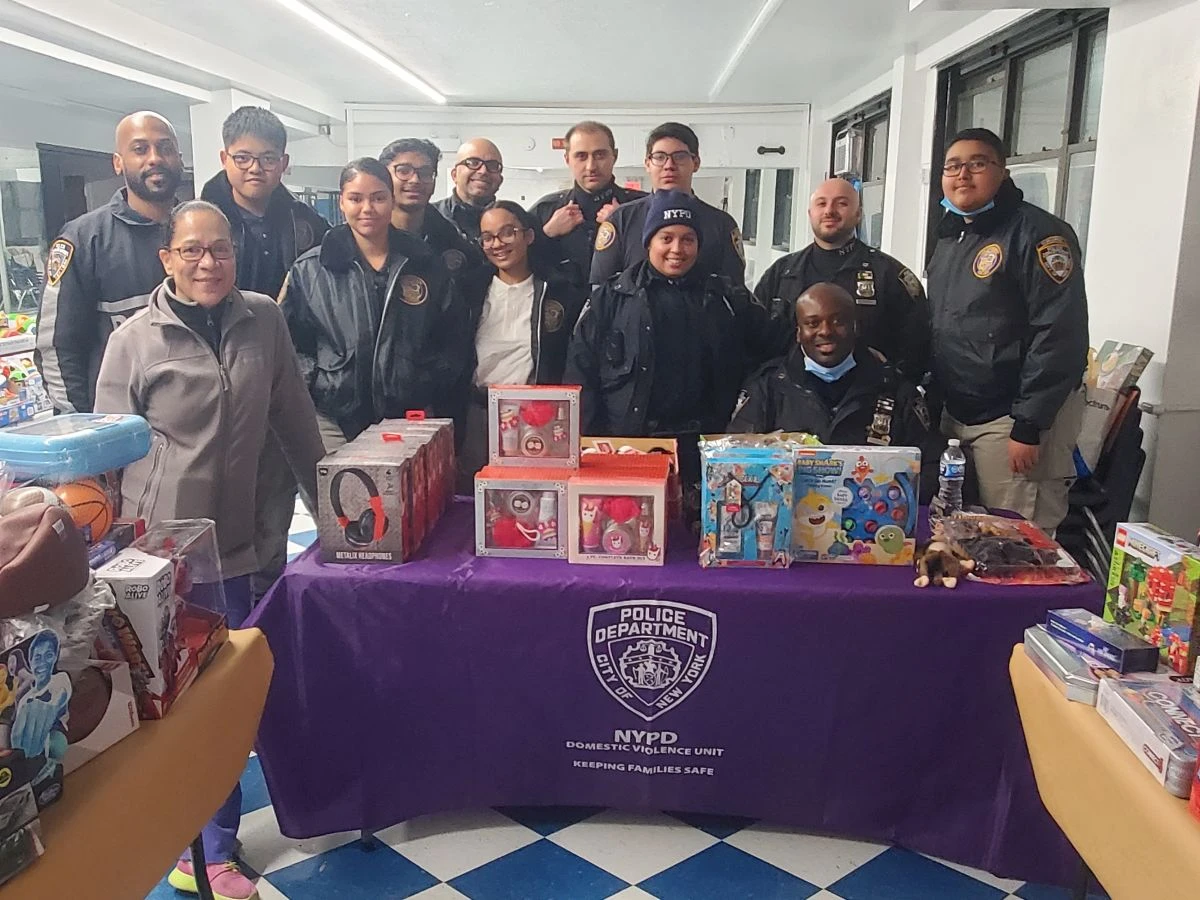 A group gathers around donated gifts at the holiday toy drive.