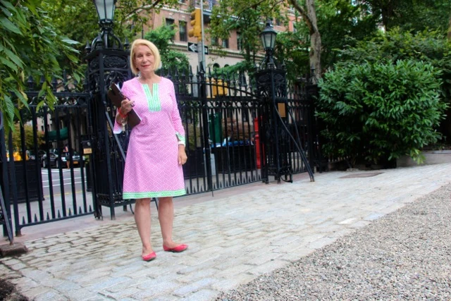Arlene Harrison stands beside the Park’s north gate and cobblestone threshold.