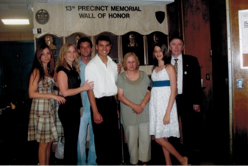 The Sanchez family in front of the 13th Precinct Memorial Wall of Honor.